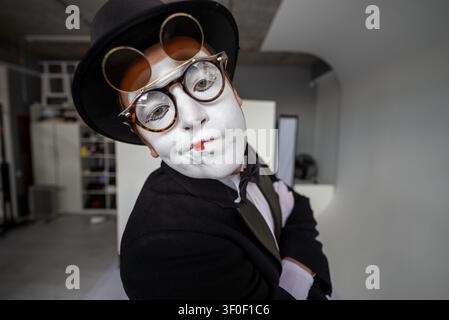 Nahaufnahme eines skurrilen Porträts eines männlichen Pantomimen in schräger Kopfpose Stockfoto