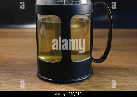 Nahaufnahme von Kräuter-Salbei-Tee, der in einer Glas-French-Press braut Stockfoto
