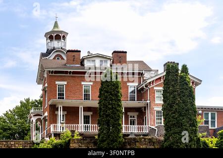 Galena, Illinois, USA - 7. Juni 2026: Historisches rotes Backsteinhaus mit einer markanten Kuppel, umlaufender Veranda und architektonischen Details aus der viktorianischen Ära Stockfoto