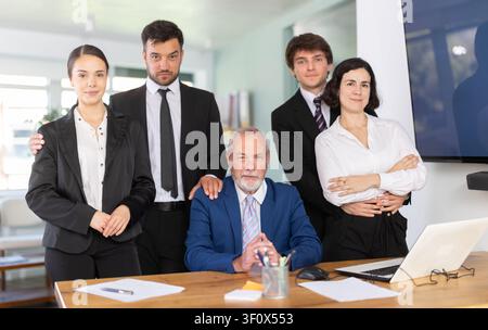 Büroangestellte stehen mit einem Paar vor dem Hintergrund des Büros Stockfoto