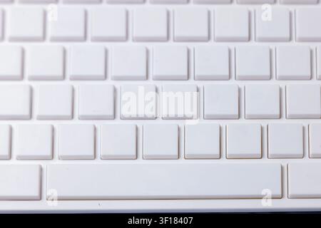 Top-Down-Ansicht, die Reihen sauberer weißer quadratischer Tasten auf einer leeren Computertastatur zeigt. Hochwertiges Foto Stockfoto