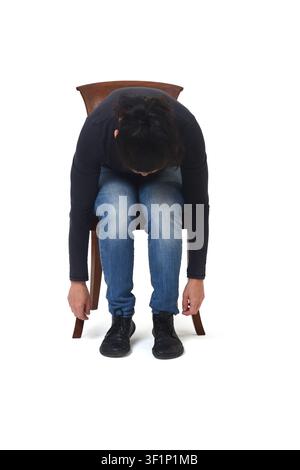 Vorderansicht einer gebrochenen Frau, die auf einem Stuhl sitzt, mit herabhängenden Armen vor einem weißen Hintergrund. Stockfoto