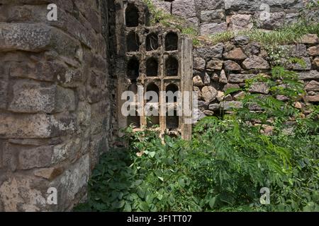 Alte Steinmauer mit historischen architektonischen Nischen und verwitterten Festungsmauern Stockfoto