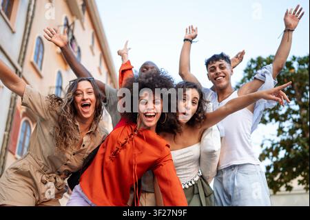 Multikulturelle Gruppe genießt einen unbeschwerten Moment, während sie zusammen reist und in der Stadt lacht Stockfoto