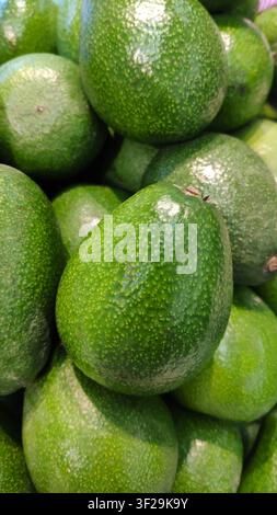 Frische grüne Avocados, Blick von oben, Vollformat, Makro-Hintergrund Stockfoto