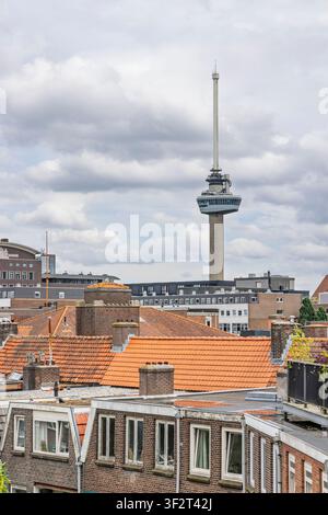 Rotterdam, Niederlande – 03. Juni 2026 – Der ikonische Euromast-Beobachtungsturm ragt in einen bewölkten Himmel über traditionellen orangefarbenen Dachplatten Wohngebäuden Stockfoto