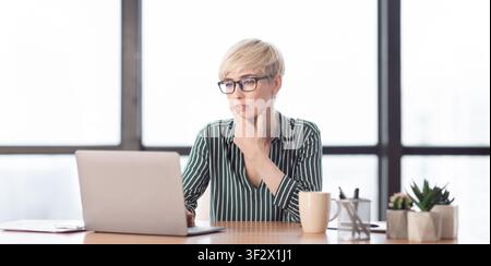 Serious Lady At Laptop Working Sitting In Modern Office, Panorama Stockfoto