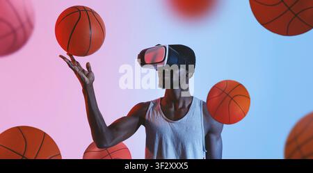 Mann mit VR-Headset, der einen Basketball balanciert, konzentrierter afroamerikanischer Mann, Sportkonzept Stockfoto