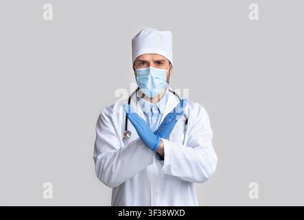 Arzt in Schutzkleidung Gesturing STOP mit gekreuzten Händen Stockfoto