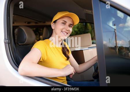 Kurier mit Kartons im Auto. Lieferservice Stockfoto