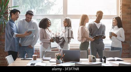 Gruppe von multirassischen Jugendlichen, die Ideen teilen, während der Kaffee bricht Stockfoto