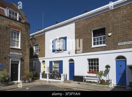 Ruhige Altstadtstraße mit restaurierten alten Backsteinhäusern mit blau gestrichenen Türen und Fensterläden, Chelsea, London, Großbritannien, England, Großbritannien Stockfoto