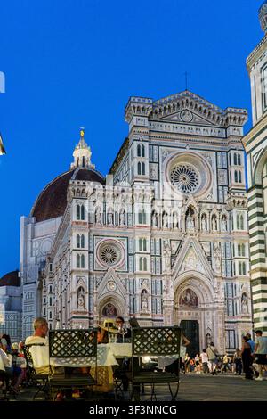 Florenz, Toskana, Italien. 28. Mai 2026. - Touristen speisen im Freien unter dem Dämmerhimmel neben der historischen und majestätischen Kathedrale von Florenz in Italien. Stockfoto