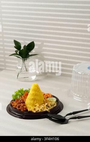 Tumpeng Mini Nasi Kuning oder kleiner konischer gelber Reis, indonesische festliche Speisen für Indoneia Unabhängigkeitstag 17 Agustus Stockfoto