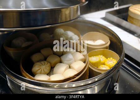 Bambuskörbe gefüllt mit Baozi und Mais werden in einem großen Dampfgarer gedämpft. Diese Kochmethode bewahrt den Geschmack und die Textur des Essens. Hoa Lu, Vi Stockfoto