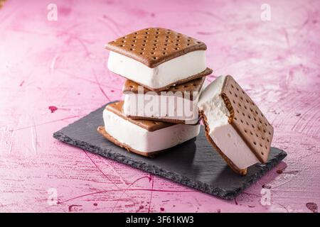 Leckere Eiscremesandwiches auf rosa Tisch Stockfoto