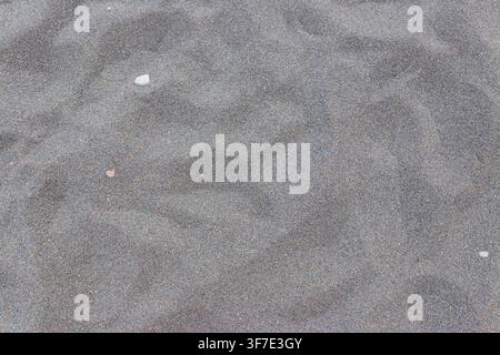 Textur von schwarzem vulkanischem Sand als Hintergrund Stockfoto