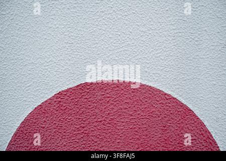 Rote Halbkreisform, die auf einen rauen weißen strukturierten Betonwandhintergrund gemalt ist Stockfoto