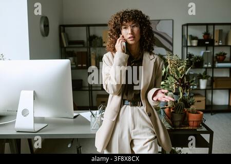 Geschäftsfrau arbeitet und telefoniert in einem modernen Büro Stockfoto