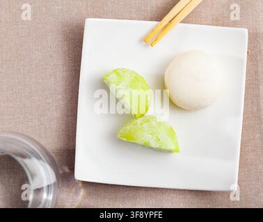 Mochi-Eis und Holzstöcke auf japanischem Teller Stockfoto