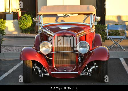 Vorderansicht eines Customized Candy Apple Red 1932 Ford Phaeton Hot Rod, der auf einer Outdoor-Autoausstellung ausgestellt ist. Stockfoto