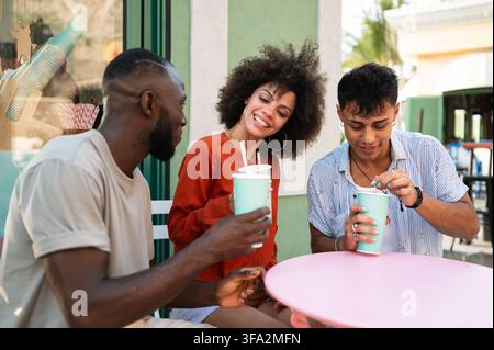 Vielfältige Gruppe glücklicher junger Freunde treffen sich an einem tropischen Strand, um Freundschaft und Einheit zu feiern Stockfoto
