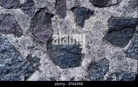 Wand aus natürlichem Granitstein. Nahaufnahme. Stockfoto
