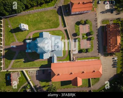 Luftaufnahme der historischen Liskiava-Kirche der Heiligen Dreifaltigkeit und des Dominikanerklosters mit rot gedeckten Dächern, Steinmauern und Grün Stockfoto