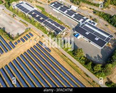 Luftaufnahme einer großen Industrieanlage mit Solarpanels auf den Dächern und einer bodengestützten Solarfarm im Vordergrund in Korbach, Hessen, Deutschland Stockfoto
