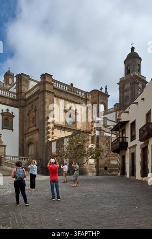 Las Palmas de Gran Canaria, Spanien – 21. August 2026: Touristen fotografieren die Steinfassade und den Glockenturm der Kathedrale von Santa Ana von der Plaza del P aus Stockfoto