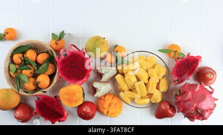 Top-Down-Blick auf verschiedene tropische Früchte, Mango, Drachenfrucht, Orangenmandarine, Wasserapfel, Jackfrucht Stockfoto