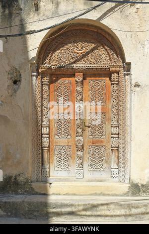 Alte kunstvoll geschnitzte Holztür, Stone Town, Sansibar, Tansania, Ostafrika. Stockfoto