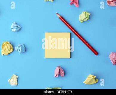 Bunte leere Papieraufkleber in verschiedenen Farben und Holzbleistift auf blauem Hintergrund, Kopierraum Stockfoto