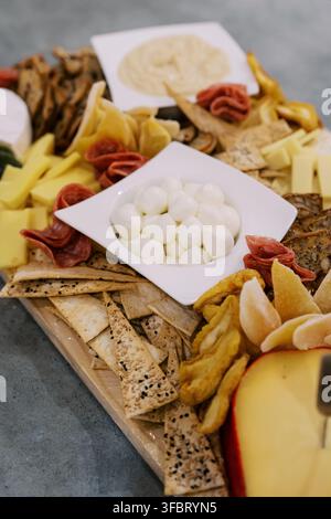 Gourmet-Käseplatte mit Crackern und Dips Stockfoto