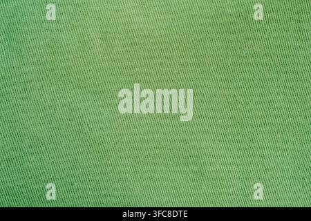 Vollbild-Oberansicht von flachem hellgrünem Baumwoll-Twill-Stoff mit diagonalem Webmuster horizontal, Stockfoto. Stockfoto