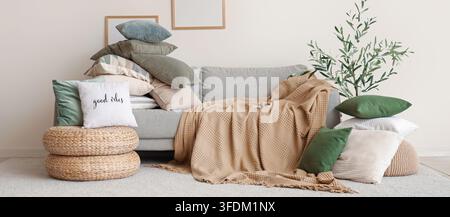 Heimkomfort und Innendesign, gemütliches Wohnzimmer mit weichen Kissen und beiger Überwurfdecke auf einem grauen Sofa für Entspannung und Lifestyle-Atmosphäre Stockfoto