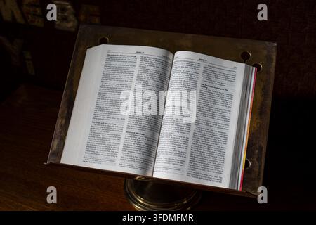 Oxford, Oxfordshire, England, 20. August 2026. Nahaufnahme einer offenen Heiligen Bibel, die auf einem Lesepult in einer Kirchenkapelle ruht. Stockfoto