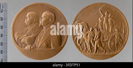 Zwei runde Bronzemedaillen aus dem Ersten Weltkrieg mit erhabenen Relieffiguren, darunter eine Medaille mit zwei Männern im Profil und eine andere mit einem von Pferden gezogenen Wagen und einer stehenden Figur, die eine Fahne hält, geschaffen von Henry Nocq, einem französischen Autor und Sammler von Medaillen und Auszeichnungen. Stockfoto