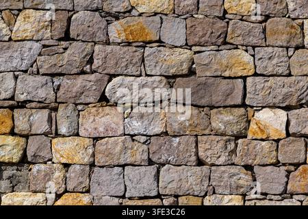 Alte rustikale Steinmauer-Textur-Hintergrund Stockfoto