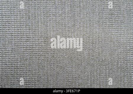 Oberansicht einer grauen Strickstofftextur mit feinem Wollgarngewebe-Muster. Nahtloser textile Hintergrund, ideal für Wintermode-Branding Stockfoto