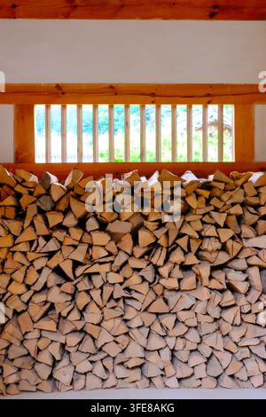 Ordentlich gestapeltes Brennholz in einem traditionellen koreanischen Hanok-Gebäude mit hölzernen Fensterläden in Korea. Stockfoto