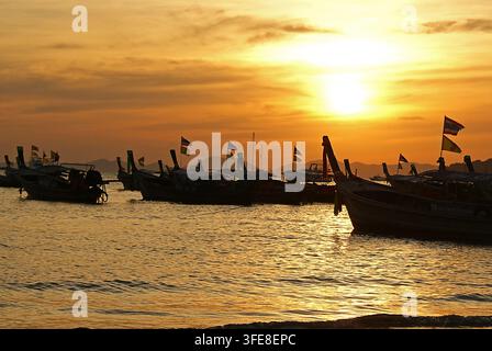 Traditionelle Langboot mit langem Heck liegen am Abend am Strand von Ao Nang in Krabi, Thailand, vor Anker. Stockfoto