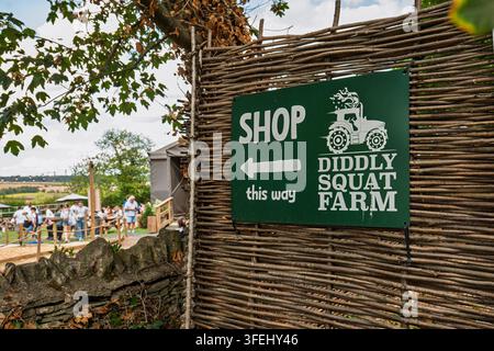 Chipping Norton, England, 19. August 2026. Richtungsschild für Diddly Squat Farm Shop, das an einem gewebten Holzzaun auf dem Land montiert ist Stockfoto