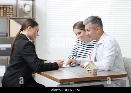 Notar arbeitet mit Klienten am Tisch im Büro Stockfoto