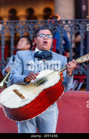 SAN MIGUEL DE ALLENDE, MEXIKO – 02. NOVEMBER 2019: Ein Mariachi-Musiker singt und spielt Gitarre in San Miguel de Allende. Die lebhafte Aufführung fängt Stockfoto