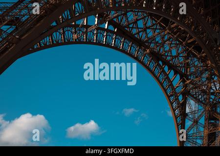 Eiffelturm-Struktur, die einen blauen Himmel einrahmt, ein Pariser Wahrzeichen, das Reisen, Architektur und Ingenieurwesen in Frankreich repräsentiert Stockfoto