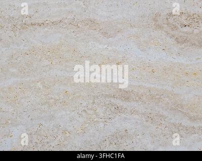 Nahaufnahme der Textur einer Creme-Travertin-Marmorsteinoberfläche Stockfoto
