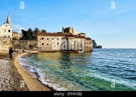 Mittelalterliche Steinmauer einer Festung auf einem Kiesstrand entlang der Adriaküste in der Altstadt von Budva, Montenegro Stockfoto