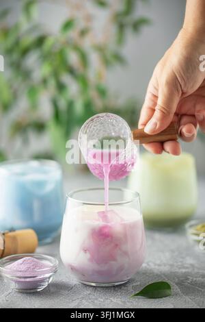 Rosafarbener Matcha-Tee mit Eismilch. Gesundes veganes Getränk Matcha Taro Latte Stockfoto