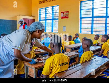 Wie ein Krankenhaus-Mahlzeitprogramm ein breiteres Ernährungssystem in Ruanda aufbaut Isabelle Kamariza, Gründerin und Präsidentin von SolidAfrica, im Austausch mit Schulkindern in Ruanda. Foto: Mit freundlicher Genehmigung von SolidAfrica Ruanda Copyright: xx Stockfoto